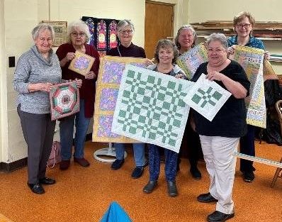 Our quilters are showing some of their work for this project in this photo.